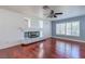 Bright living room with a fireplace, hardwood floors, and large windows at 3633 Fox Heather Dr, Las Vegas, NV 89129