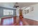 Spacious living room with hardwood floors, ceiling fan, and abundant natural light at 3633 Fox Heather Dr, Las Vegas, NV 89129