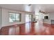Open-concept living area featuring hardwood floors, backyard access, a fireplace and kitchen access at 3633 Fox Heather Dr, Las Vegas, NV 89129