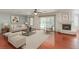 Bright living room features a fireplace, hardwood floors, and sliding glass door to backyard at 3633 Fox Heather Dr, Las Vegas, NV 89129