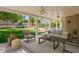 Inviting covered patio with comfortable seating overlooking the landscaped backyard and sparkling pool at 3633 Fox Heather Dr, Las Vegas, NV 89129