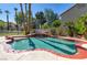 Inviting backyard pool features a rock waterfall, lush landscaping, and a brick-lined edge at 3633 Fox Heather Dr, Las Vegas, NV 89129