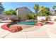 Inviting backyard swimming pool with rock features, perfect for relaxing and enjoying the outdoors at 3633 Fox Heather Dr, Las Vegas, NV 89129