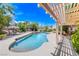 Beautiful backyard with a swimming pool, covered seating, and well-maintained landscaping at 364 Clark Dr, Henderson, NV 89074