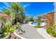 Lush backyard oasis featuring mature landscaping, pool, spa, and covered patio at 364 Clark Dr, Henderson, NV 89074