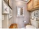 Convenient half-bathroom with a neutral color scheme, decorative mirror, and functional layout at 364 Clark Dr, Henderson, NV 89074