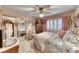 Charming bedroom with a ceiling fan, mirrored closet doors, and soft lighting, creating a relaxing and stylish retreat at 364 Clark Dr, Henderson, NV 89074