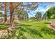 Scenic view of the neighborhood park with green space, mature trees, playground equipment, and walking trail at 364 Clark Dr, Henderson, NV 89074