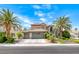 Charming two-story home featuring a three-car garage, desert landscaping and mature palm trees at 364 Clark Dr, Henderson, NV 89074
