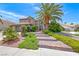 Beautiful two-story home with a tile roof, mature trees, lush landscaping, and a three-car garage at 364 Clark Dr, Henderson, NV 89074
