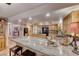 A kitchen has stone countertops and seating, and is open to the adjoining rooms at 364 Clark Dr, Henderson, NV 89074