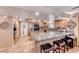 A bright kitchen with tile flooring features an island with bar seating and neutral stone countertops at 364 Clark Dr, Henderson, NV 89074