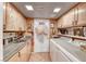 Well-appointed laundry room featuring wood cabinets, granite countertops, and convenient washer and dryer at 364 Clark Dr, Henderson, NV 89074