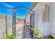 Enclosed side yard with an iron gate and pergola, offering privacy and a charming transition to the backyard at 364 Clark Dr, Henderson, NV 89074