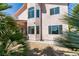 Tan stucco home featuring mature landscaping and multiple windows providing natural light at 3766 Port Ritchey St, Las Vegas, NV 89147
