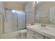 Bright bathroom with a shower/tub combination, vanity with storage, and frosted glass doors for privacy at 3766 Port Ritchey St, Las Vegas, NV 89147