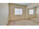 Bedroom with neutral walls, carpeted floors and a mirrored closet reflecting the natural light from the window at 3766 Port Ritchey St, Las Vegas, NV 89147