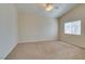 Bright bedroom with neutral walls and carpeted floor, illuminated by a ceiling fan and natural light at 3766 Port Ritchey St, Las Vegas, NV 89147