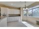 Bright dining area features white cabinets, granite countertops and natural light at 3766 Port Ritchey St, Las Vegas, NV 89147