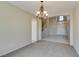Sunlit dining room with a stylish chandelier, neutral carpet, and interior view at 3766 Port Ritchey St, Las Vegas, NV 89147