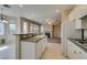 Bright kitchen featuring granite countertops, white appliances, and an open layout to the living area at 3766 Port Ritchey St, Las Vegas, NV 89147