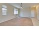 Spacious living area with neutral carpet, multiple windows, and access to hallway at 3766 Port Ritchey St, Las Vegas, NV 89147