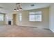 Large open living space featuring a fireplace, neutral carpet, and lots of light at 3766 Port Ritchey St, Las Vegas, NV 89147