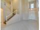Bright living room featuring soaring ceilings, tile flooring, and a staircase at 3766 Port Ritchey St, Las Vegas, NV 89147