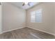 Cozy bedroom with wood-look tile flooring, a window, and a modern ceiling fan at 421 Point Sur Ave, Las Vegas, NV 89138