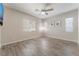 Inviting bedroom features wood look tile flooring, fan and ample natural light at 421 Point Sur Ave, Las Vegas, NV 89138