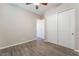 Neutral bedroom with a ceiling fan, tile floors, and sliding closet doors offers a blank canvas at 421 Point Sur Ave, Las Vegas, NV 89138