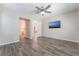 Bright bedroom with wood look tile flooring and access to both the bathroom and walk-in closet at 421 Point Sur Ave, Las Vegas, NV 89138