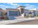 Charming single-story home with a two-car garage and manicured landscaping at 421 Point Sur Ave, Las Vegas, NV 89138