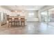 Bright kitchen features white cabinets, stainless steel appliances, a large island, and backyard access at 421 Point Sur Ave, Las Vegas, NV 89138