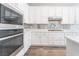 This kitchen includes stainless steel appliances, modern backsplash and ample counter space at 421 Point Sur Ave, Las Vegas, NV 89138