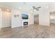 Living room featuring a cozy fireplace, wall decor, and seamless flow to other living spaces at 421 Point Sur Ave, Las Vegas, NV 89138