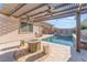 Inviting outdoor pool area with a fire pit, pergola, and mature landscaping at 421 Point Sur Ave, Las Vegas, NV 89138