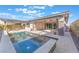 Backyard pool featuring a raised spa, pergola, ceiling fans and an outdoor kitchen at 421 Point Sur Ave, Las Vegas, NV 89138