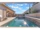 Gorgeous backyard pool with a spa, outdoor kitchen, and well-manicured landscaping at 421 Point Sur Ave, Las Vegas, NV 89138
