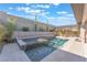 Backyard pool and spa surrounded by a retaining wall and professional landscaping at 421 Point Sur Ave, Las Vegas, NV 89138