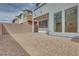 Low-maintenance backyard featuring neutral-toned gravel, a stucco wall, and a covered patio for outdoor entertaining at 4349 Tabor Peak Ave, Las Vegas, NV 89141