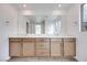 Bathroom featuring a large mirror, double sinks, and modern cabinetry with plenty of storage space at 4349 Tabor Peak Ave, Las Vegas, NV 89141