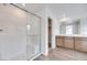 Modern bathroom with a glass-enclosed shower, wood-style floors and vanity with lots of storage at 4349 Tabor Peak Ave, Las Vegas, NV 89141