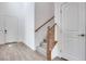 Bright entryway featuring sleek gray wood flooring, staircase, and modern doors at 4349 Tabor Peak Ave, Las Vegas, NV 89141