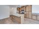 Modern kitchen featuring an island with grey countertops and natural wood cabinets at 4349 Tabor Peak Ave, Las Vegas, NV 89141