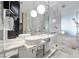 Modern bathroom with double sinks, marble tile, and glass enclosed shower and soaking tub at 4381 W Flamingo Rd # 3710, Las Vegas, NV 89103
