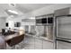 Bright modern kitchen featuring stainless steel appliances, island seating, and sleek fixtures at 4381 W Flamingo Rd # 3710, Las Vegas, NV 89103