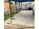 The covered back patio featuring a concrete floor, partially enclosed with a wooden railing at 4820 Mahogany Dr, Las Vegas, NV 89110
