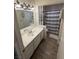 Well-lit bathroom featuring wood-style flooring, a white vanity, and a shower with a decorative striped curtain at 4820 Mahogany Dr, Las Vegas, NV 89110