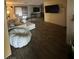 Spacious living room featuring wood-look floors, modern furniture, and a large wall-mounted television at 4820 Mahogany Dr, Las Vegas, NV 89110